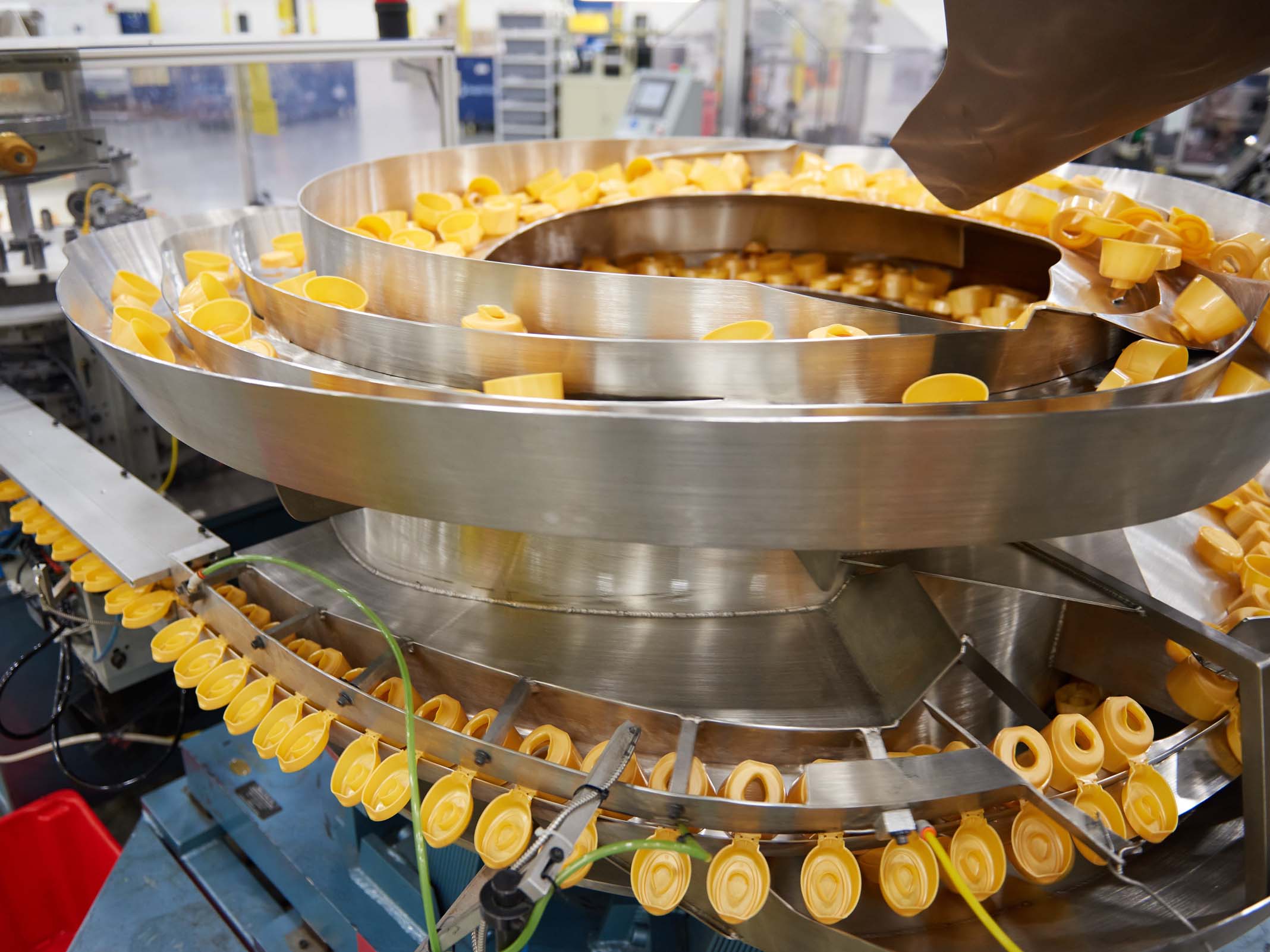 Coffee creamer closures on assembly line