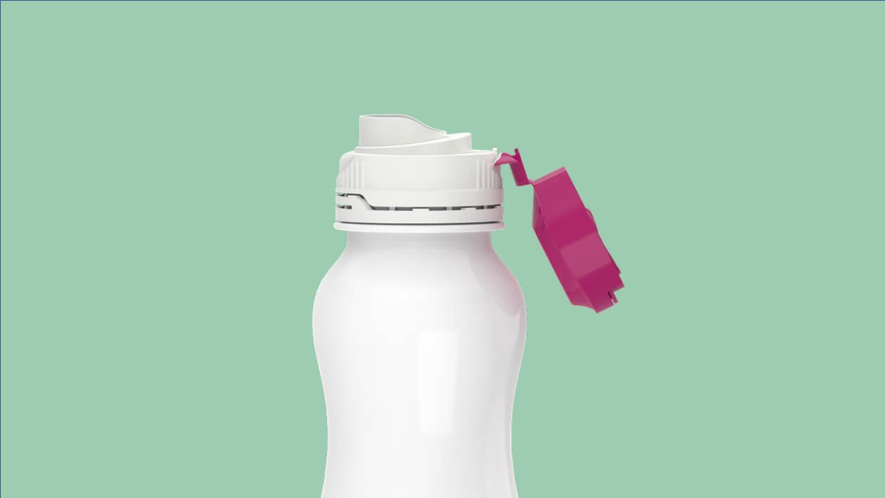Pink and white Kiso closure on white milk bottle on green background